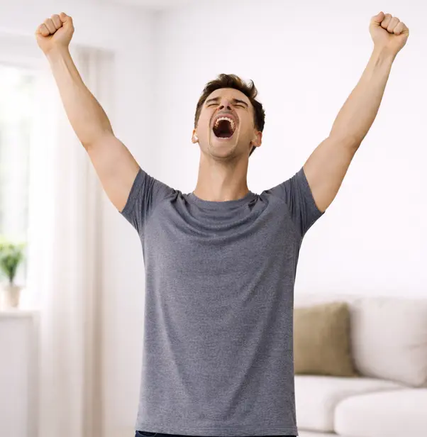Person with both arms raised in a clear V-shape, expression of joy and triumph, head tilted back
