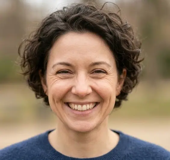 Person displaying a genuine Duchenne smile with crow's feet around the eyes and raised cheeks