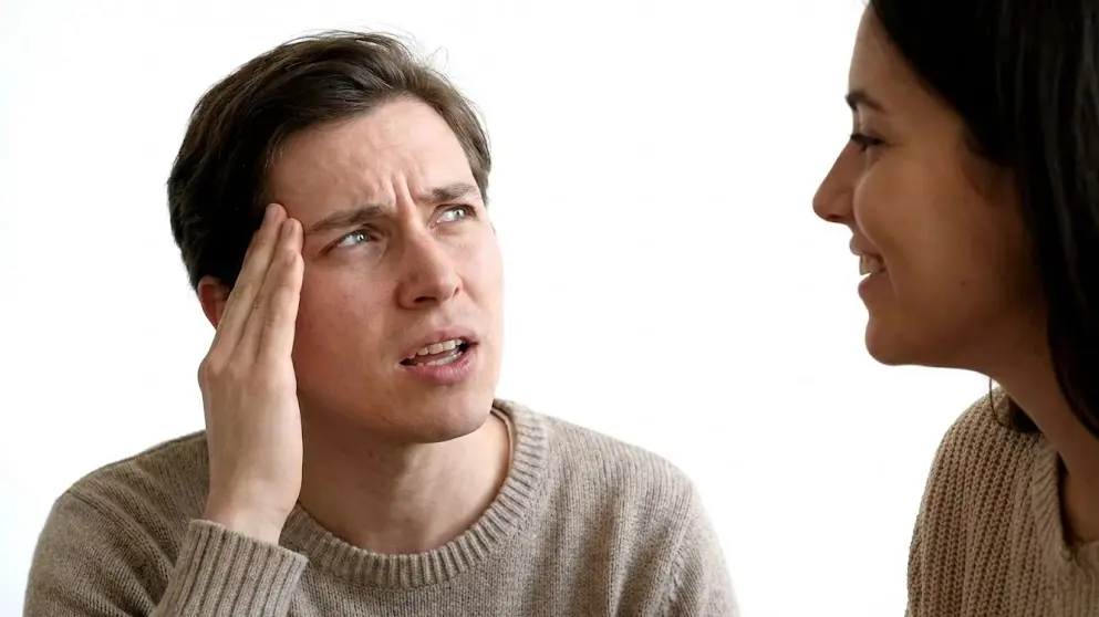 Person struggling to recall a name during conversation